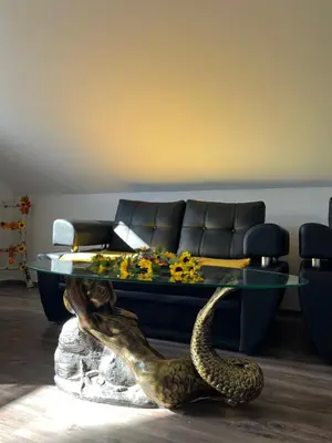 a living room with a couch and a glass table at Secret Paradise apartment in Zgornje Gorje