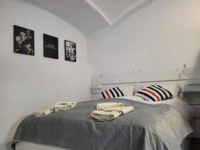 a bedroom with a bed with towels on it at MK Studio in Maribor