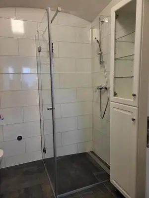 a bathroom with a shower with a glass door at MK Studio in Maribor