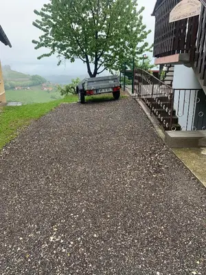 a driveway with a car parked next to a house at Apartment Gajsek in Zavrč