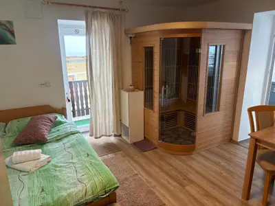 a bedroom with a large wooden cabinet and a bed at Apartment Gajsek in Zavrč
