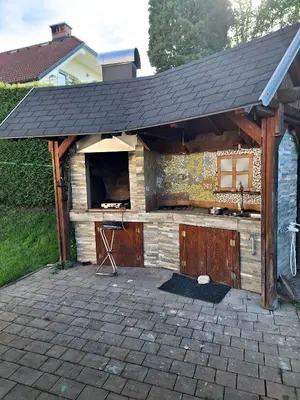 an outdoor bar with a roof on a patio at Apartment Zupan in Preddvor