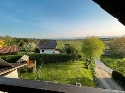 a view from the balcony of a house with a yard at Apartment Zupan in Preddvor