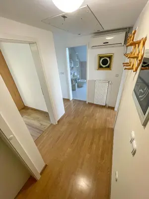 an empty living room with a hallway and a staircase at Apartment Zupan in Preddvor