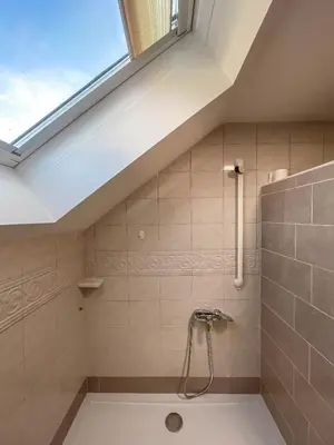 a bathroom with a bath tub with a window at Apartment Zupan in Preddvor