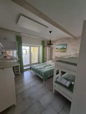 a bedroom with two bunk beds and a sink at Helena in Trzin