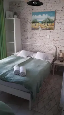 a bedroom with a bed with two towels on it at Helena in Trzin