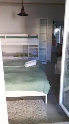 a bedroom with two bunk beds and a rug at Helena in Trzin