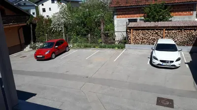 two cars are parked in a parking lot at Helena in Trzin