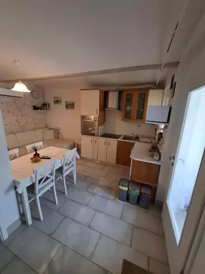 a kitchen and dining room with a table and chairs at Helena in Trzin