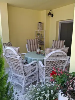 a patio with wicker chairs and a table at Helena in Trzin