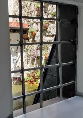 an open window with a view of a garden at Way to the Castle in Ljubljana