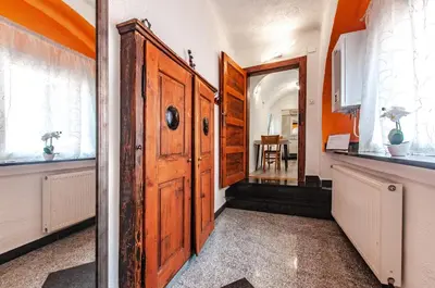 a hallway with an open wooden door in a house at Way to the Castle in Ljubljana