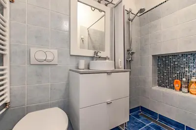 a bathroom with a toilet and a sink and a mirror at Way to the Castle in Ljubljana