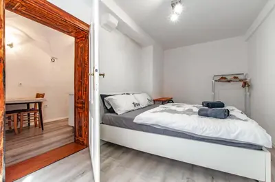a bedroom with a large bed and a table at Way to the Castle in Ljubljana