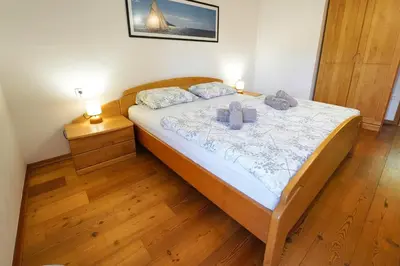 a bedroom with a bed with two towels on it at Apartments Pr' Pavleto in Bohinj