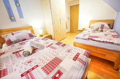 two beds in a room with two beds sidx sidx sidx at Apartments Pr' Pavleto in Bohinj