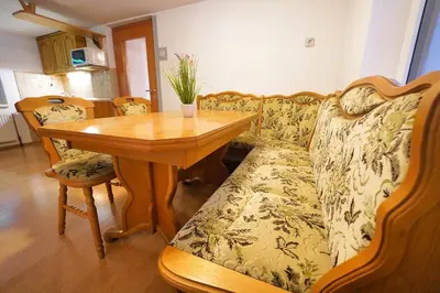 a living room with a couch and a wooden table at Apartments Pr' Pavleto in Bohinj