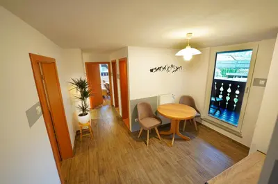 a dining room with a table and chairs and a window at Apartments Pr' Pavleto in Bohinj