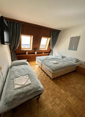 a bedroom with two beds and a flat screen tv at App Bovec in Bovec