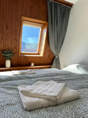 two beds in a room with a window at App Bovec in Bovec