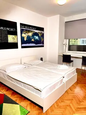 a bedroom with a white bed in a room at Apartment KOZOLEC - best central location in Ljubljana