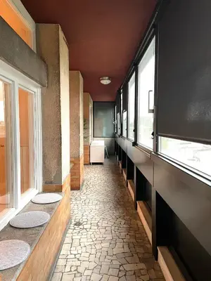 a hallway with windows and a room with tile floors at Apartment KOZOLEC - best central location in Ljubljana