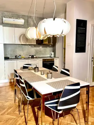 a kitchen with a table and chairs in a room at Apartment KOZOLEC - best central location in Ljubljana