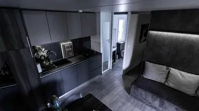 a living room with a couch and a kitchen at Nord mobile house in Velenje