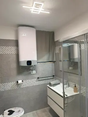 a bathroom with a sink and a shower at Apartma Anže Samec in Dobravlje