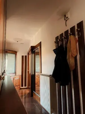 a room with a hallway with a radiator and a door at Apartma Domačija Bole in Sežana