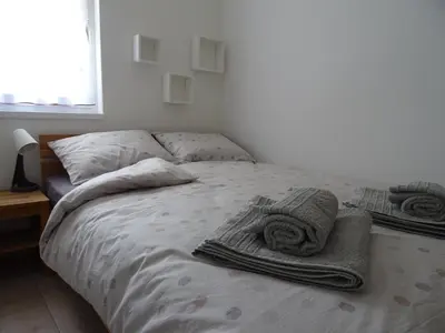 a bed with towels and pillows on it in a bedroom at Apartment Josephine in Tolmin