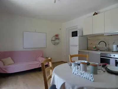 a living room with a table and a pink couch at Apartment Josephine in Tolmin