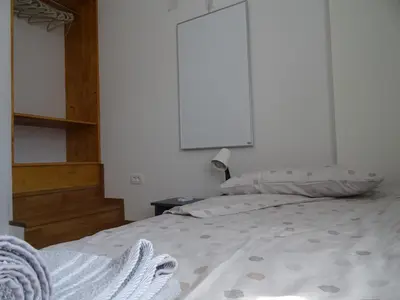 a bedroom with a white bed with a white wall at Apartment Josephine in Tolmin