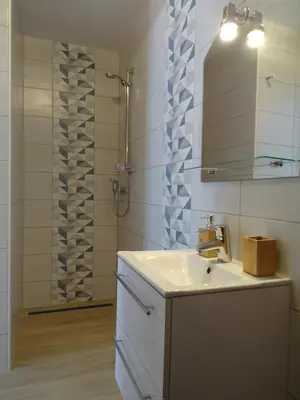 a bathroom with a sink and a mirror and a shower at Apartment Josephine in Tolmin