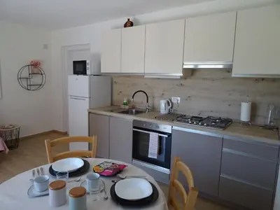 a kitchen with a table and a stove top oven at Apartment Josephine in Tolmin