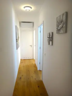 a hallway with white walls and a hard wood floor at Apartment 14 Luna in Bovec