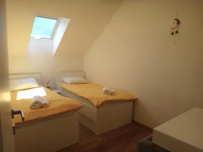 two beds in a small room with a window at Apartment 14 Luna in Bovec