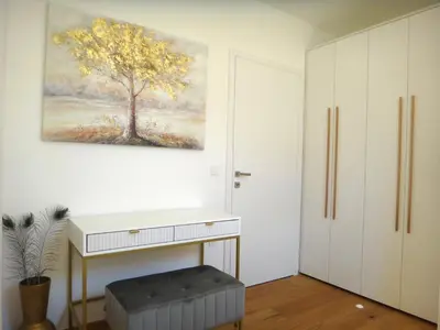 a room with a white desk and a painting on the wall at Apartment 14 Luna in Bovec
