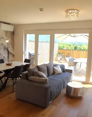 a living room with a couch and a table at Apartment 14 Luna in Bovec