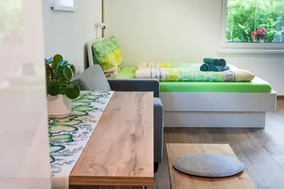 a living room with a table and a couch at apartment Sun Di Bohinj in Bohinj