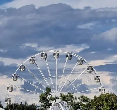 a large ferris wheel in a park under a cloudy sky at Brunarica Dolce Vita 85 in Brežice