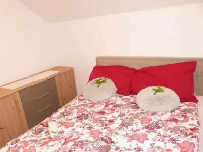 a bedroom with a bed with two white pillows at Vineyard cottage Mavrica in Dragatuš