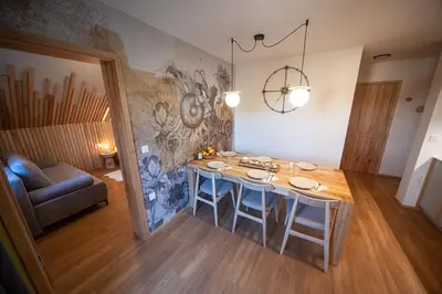 a living room with a table and a couch at Turizem na kmetiji Rdečnik in Slovenj Gradec