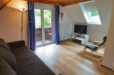 a living room with a couch and a tv at APARTMAJI-SOBE-PRI UKCU Bohinj in Bohinj