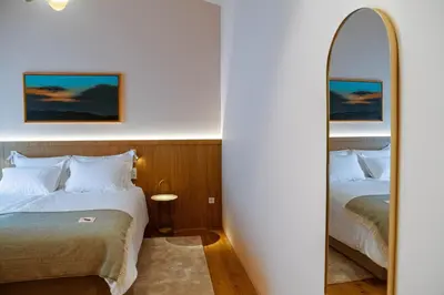 a hotel room with two beds and a mirror at Posestvo Ščurek wine in Dobrovo