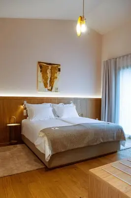 a bedroom with a large bed and a window at Posestvo Ščurek wine in Dobrovo