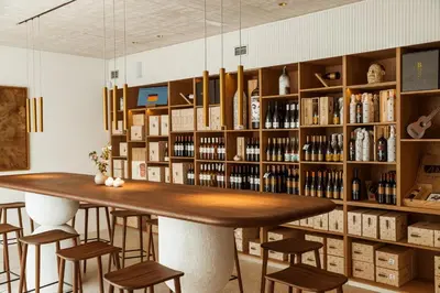 a bar in a room with shelves of wine bottles at Posestvo Ščurek wine in Dobrovo
