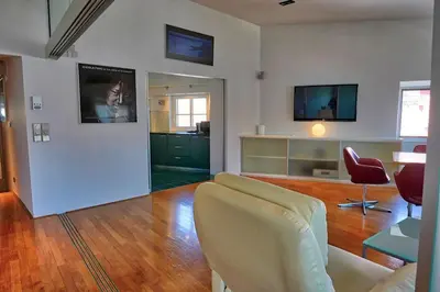 a living room with a couch and two chairs at Poet Apartment in Ljubljana