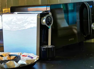 a microwave oven sitting next to a plate of food at Poet Apartment in Ljubljana